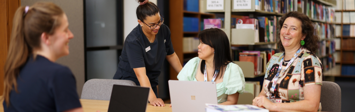 #caption104718 People sitting in the Austin Library bookroom